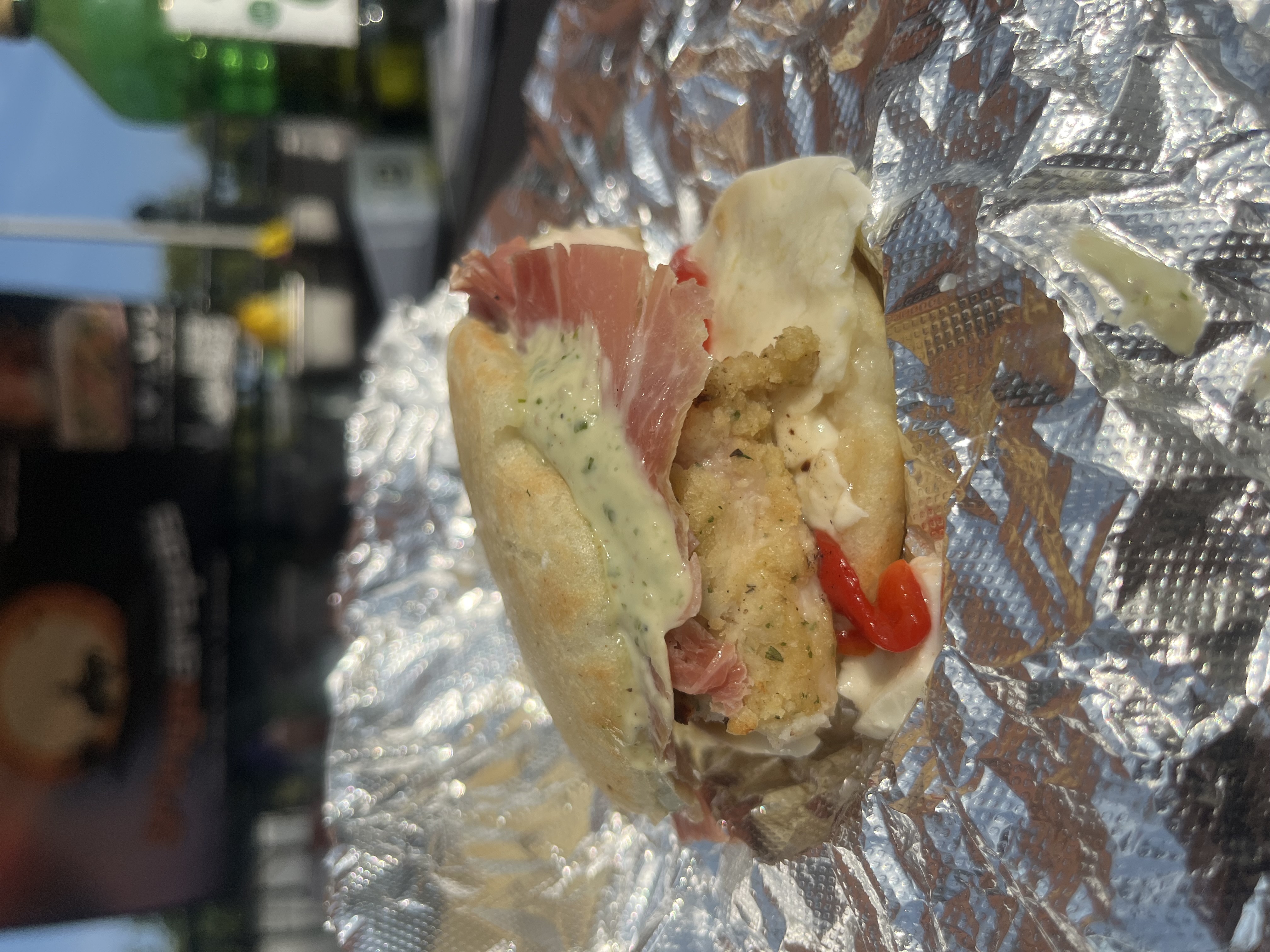Chicken milanese melt with fresh mozzarella, pesto aioli and balsamic glaze on an arepa